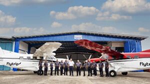 Flytrip team in front of two airplanes and hangar